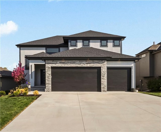 prairie-style house featuring concrete driveway, stucco siding, stone siding, and a garage