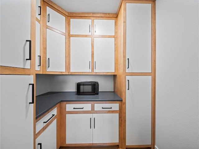 kitchen featuring freestanding refrigerator and dark countertops