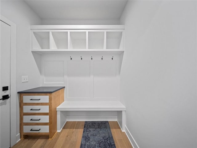 mudroom featuring light wood-style floors and baseboards