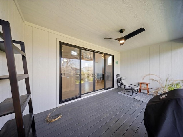 wooden terrace featuring a ceiling fan and area for grilling