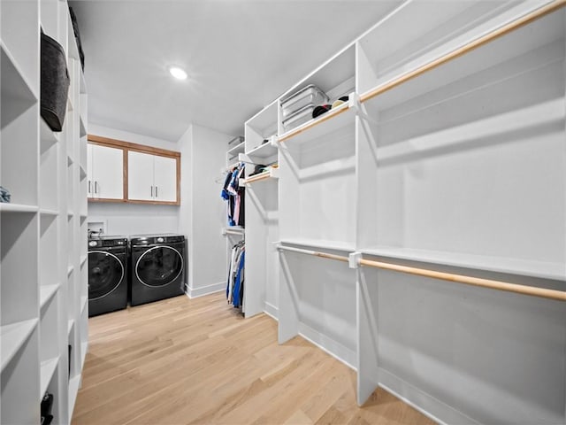 spacious closet with light wood-type flooring and washer and clothes dryer
