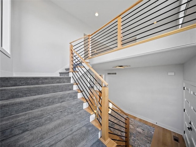 stairs featuring baseboards, recessed lighting, wood finished floors, and visible vents