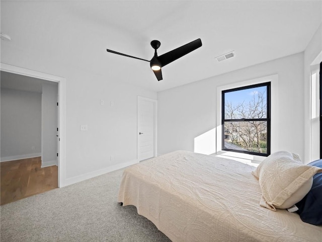 bedroom with baseboards, carpet, a ceiling fan, and visible vents