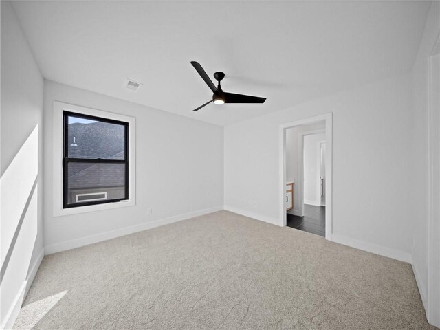 unfurnished bedroom featuring baseboards, ceiling fan, carpet flooring, and visible vents