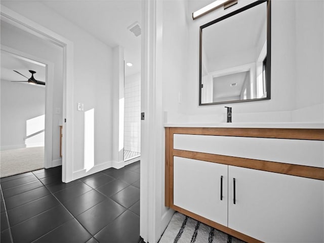 bathroom with tile patterned flooring, visible vents, vanity, baseboards, and a ceiling fan