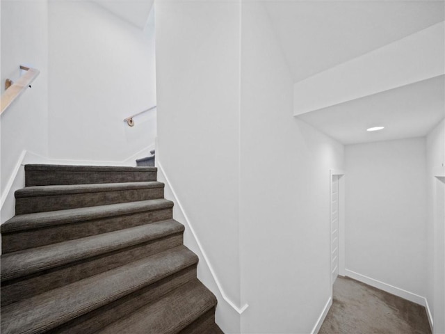 stairs with carpet floors and baseboards