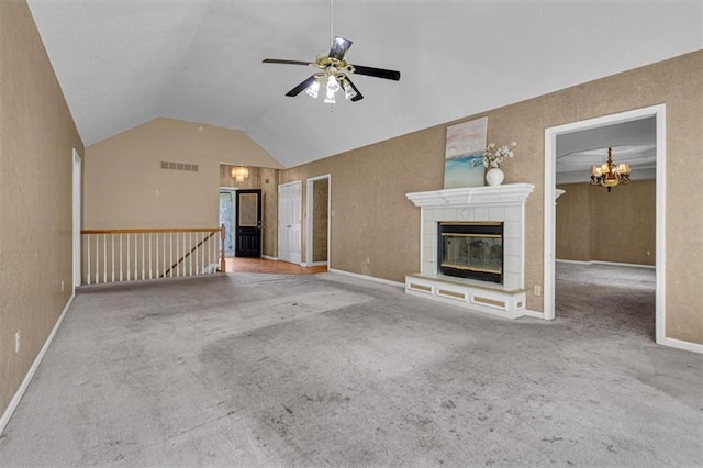 120 NW Whitlock Dr, Lees Summit, MO 64081 - unfurnished living room with lofted ceiling, carpet floors, ceiling fan, a tiled fireplace, and a chandelier