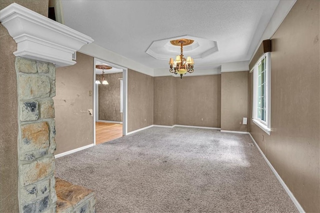 120 NW Whitlock Dr, Lees Summit, MO 64081 - spare room featuring carpet, a chandelier, a raised ceiling, a textured ceiling, and baseboards