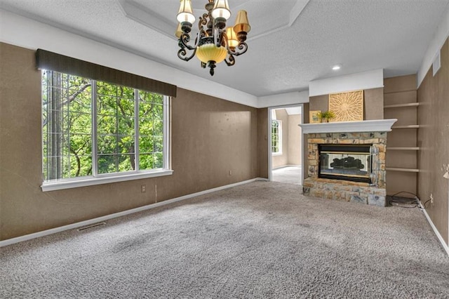 120 NW Whitlock Dr, Lees Summit, MO 64081 - unfurnished living room with plenty of natural light, a chandelier, a textured ceiling, and carpet floors