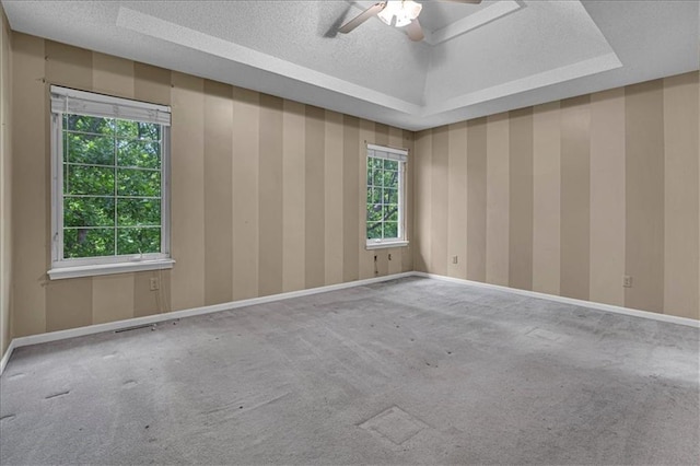 120 NW Whitlock Dr, Lees Summit, MO 64081 - carpeted spare room featuring a ceiling fan, a textured ceiling, a raised ceiling, and baseboards