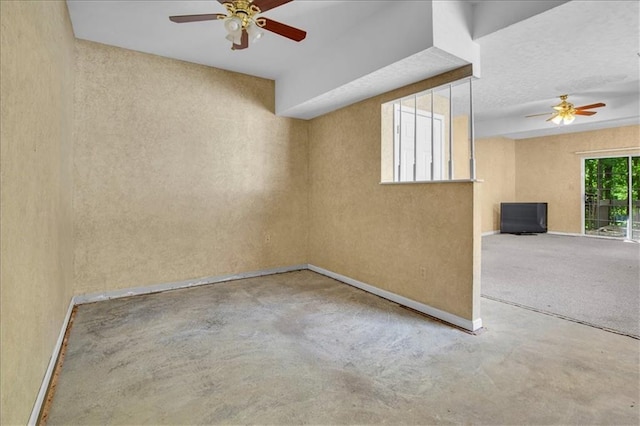 120 NW Whitlock Dr, Lees Summit, MO 64081 - spare room featuring a ceiling fan, concrete floors, a textured wall, and baseboards