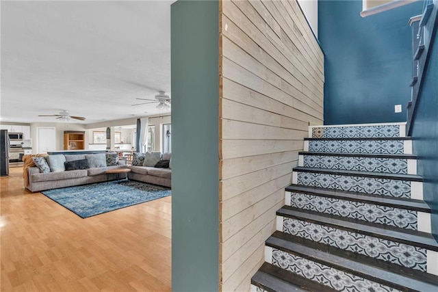 24101 S State Route K, Pleasant Hill, MO 64080 - staircase with ceiling fan, wood finished floors, and wooden walls