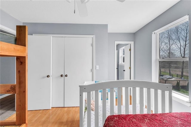 24101 S State Route K, Pleasant Hill, MO 64080 - bedroom with wood finished floors, multiple windows, a closet, and ceiling fan