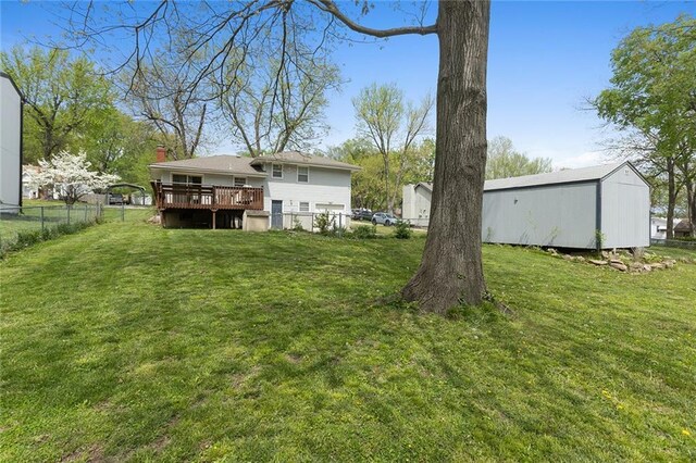 view of yard with fence and a deck