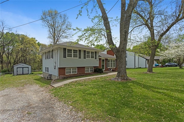 tri-level home featuring a storage shed, brick siding, a front yard, and an outdoor structure