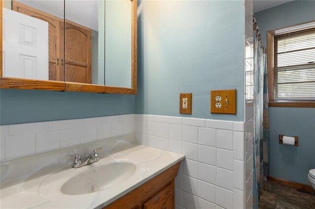 full bathroom featuring tile walls, toilet, and vanity