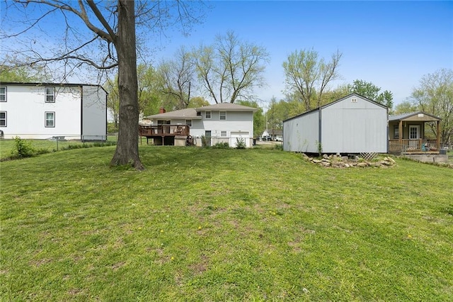 view of yard with a wooden deck and fence