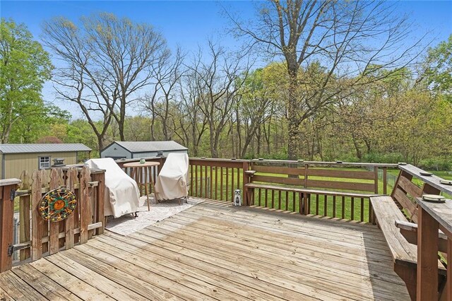 deck with an outdoor structure and a storage unit