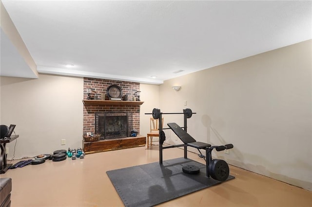 workout room with a brick fireplace and recessed lighting