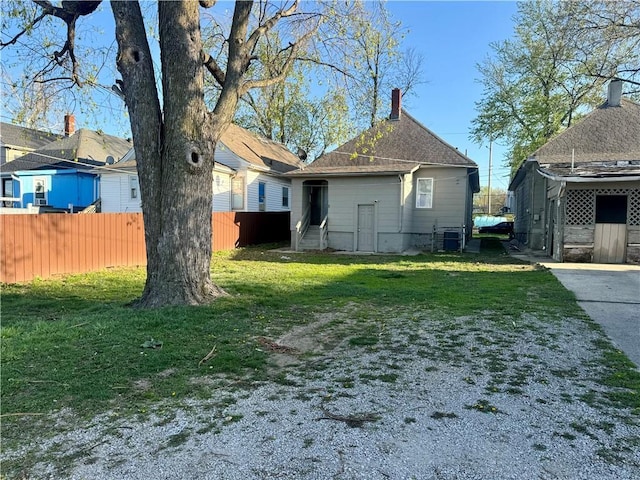 view of yard with fence and central air condition unit