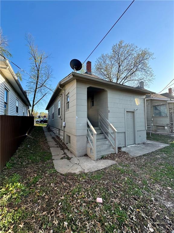 rear view of house with fence and a chimney
