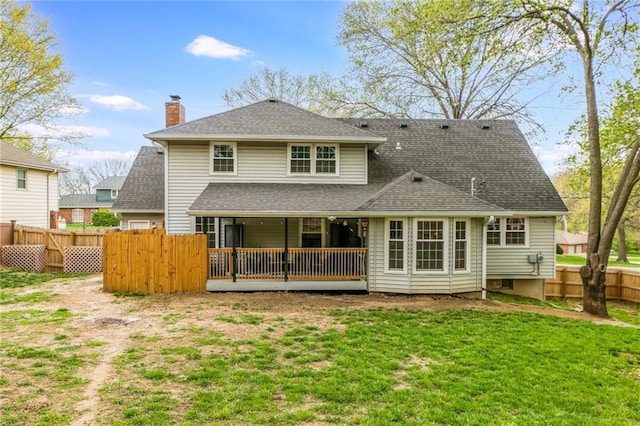 6806 N Euclid Ave, Kansas City, MO 64119 - back of property with fence private yard, a lawn, and roof with shingles