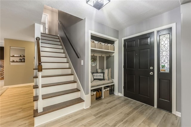 6806 N Euclid Ave, Kansas City, MO 64119 - entrance foyer featuring stairs, baseboards, and light wood-type flooring