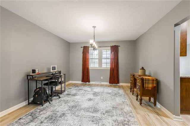 6806 N Euclid Ave, Kansas City, MO 64119 - office with baseboards, a notable chandelier, and light wood finished floors