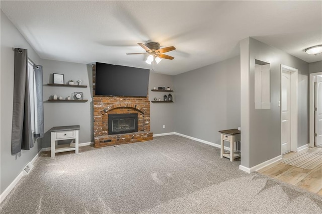 6806 N Euclid Ave, Kansas City, MO 64119 - unfurnished living room featuring carpet floors, baseboards, ceiling fan, and a fireplace