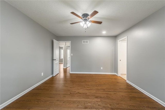 6806 N Euclid Ave, Kansas City, MO 64119 - empty room featuring ceiling fan, a textured ceiling, visible vents, wood finished floors, and baseboards