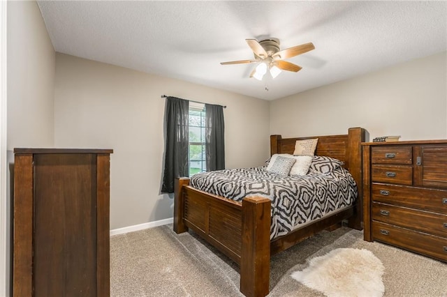 6806 N Euclid Ave, Kansas City, MO 64119 - bedroom featuring a ceiling fan, baseboards, light colored carpet, and a textured ceiling