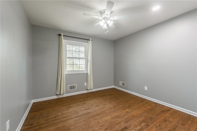 6806 N Euclid Ave, Kansas City, MO 64119 - unfurnished room featuring baseboards, a ceiling fan, dark wood-type flooring, and visible vents