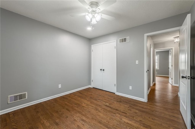 6806 N Euclid Ave, Kansas City, MO 64119 - unfurnished bedroom with visible vents, baseboards, dark wood-style flooring, and a closet