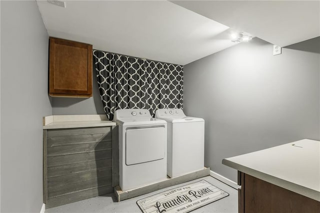 6806 N Euclid Ave, Kansas City, MO 64119 - washroom featuring baseboards, washer and clothes dryer, and cabinet space