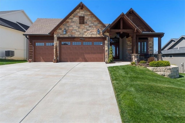 craftsman inspired home with stone siding, an attached garage, concrete driveway, and a front yard