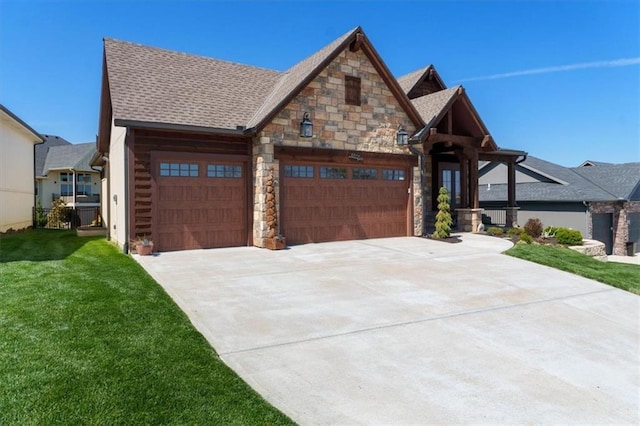 craftsman-style house with an attached garage, concrete driveway, a front lawn, stone siding, and roof with shingles