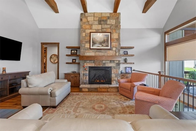 living area with a fireplace, beam ceiling, and high vaulted ceiling