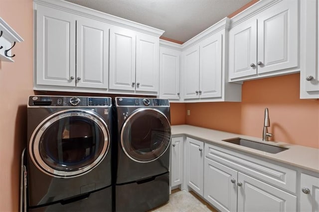 washroom with cabinet space and washer and dryer