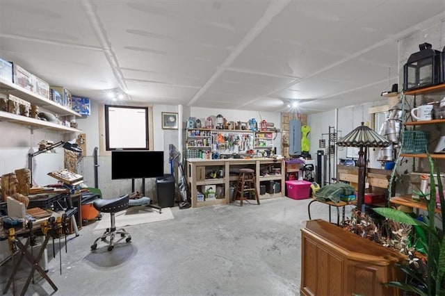 misc room with unfinished concrete floors and a workshop area
