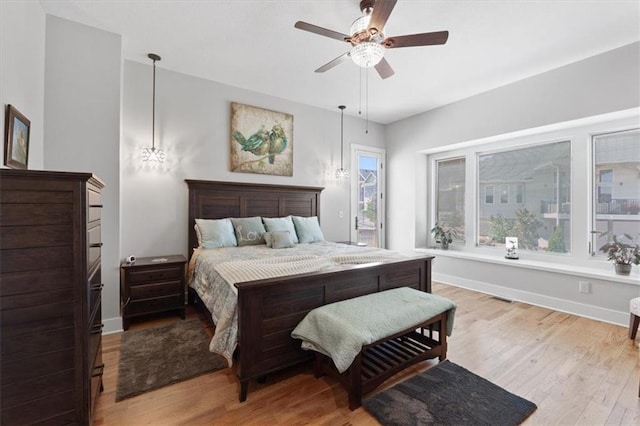 bedroom with wood finished floors, baseboards, and ceiling fan