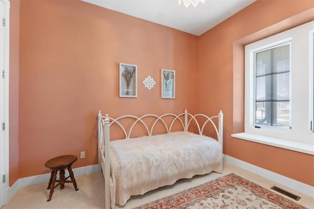 bedroom featuring baseboards and carpet