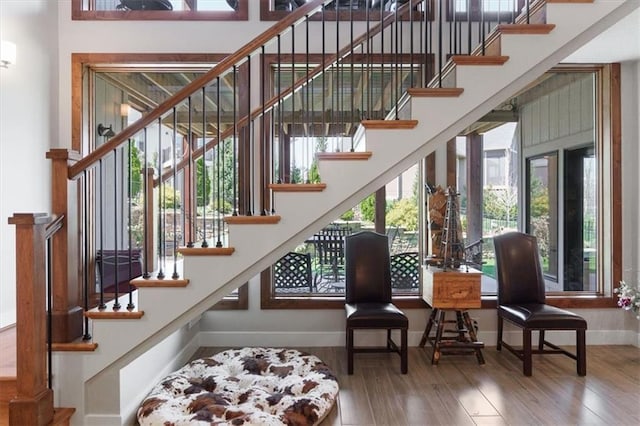 stairs featuring wood finished floors and baseboards