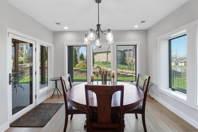 dining area with a chandelier, light wood-type flooring, baseboards, and recessed lighting