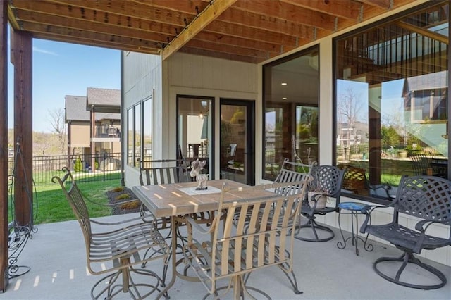 view of patio featuring fence and outdoor dining space