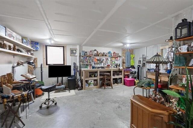 8856 Freedom St, Lenexa, KS 66227 - miscellaneous room featuring unfinished concrete flooring, a workshop area, and electric panel