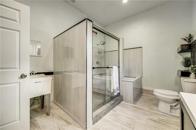 bathroom featuring toilet, recessed lighting, vanity, marble finish floor, and a stall shower
