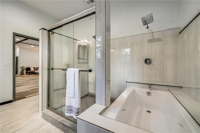 full bath featuring an enclosed shower and a bathing tub