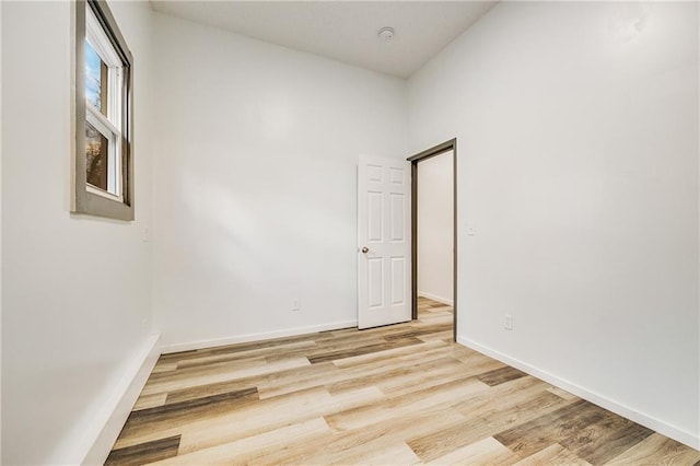 empty room featuring baseboards and wood finished floors
