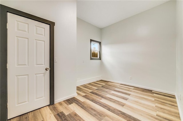 unfurnished room featuring light wood-style floors and baseboards