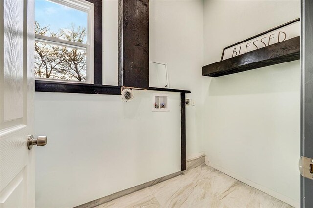 interior space with baseboards, marble finish floor, laundry area, and washer hookup